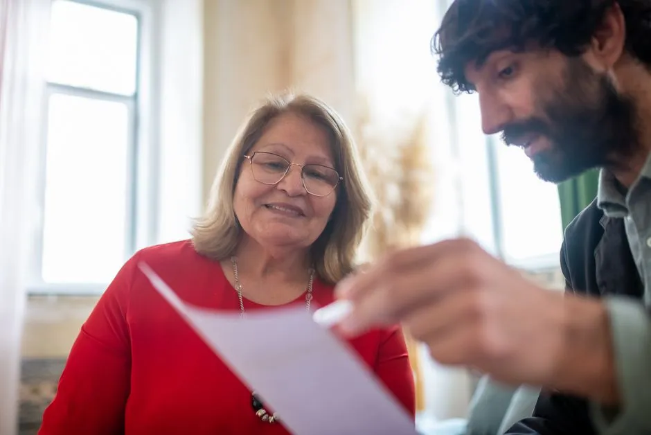 Enrollment counselor reviewing paperwork with a client, illustrative photo